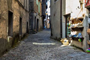 Explore the rustic charm of a cobbled street in La Alberca, Spain, lined with boutique shops and historic architecture.